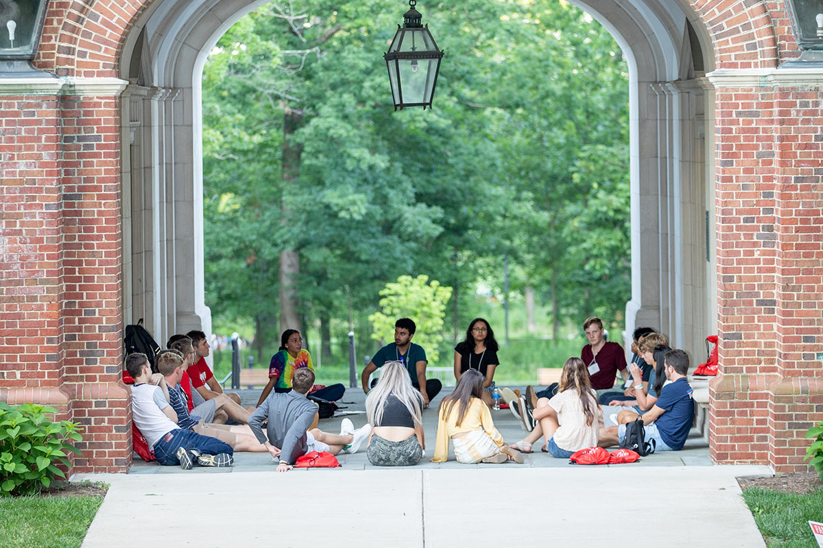 A group of incoming students sitting in a circle during new student orientation.
