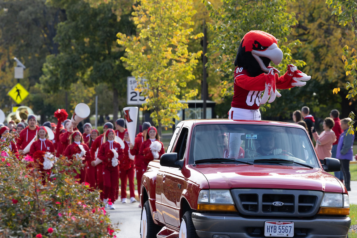 Swoop and the Miami cheerleaders welcoming the community during the Homecoming parade.