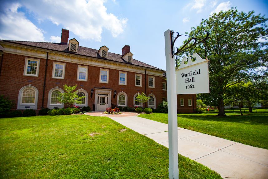 Front walkway to Warfield Hall with sign.