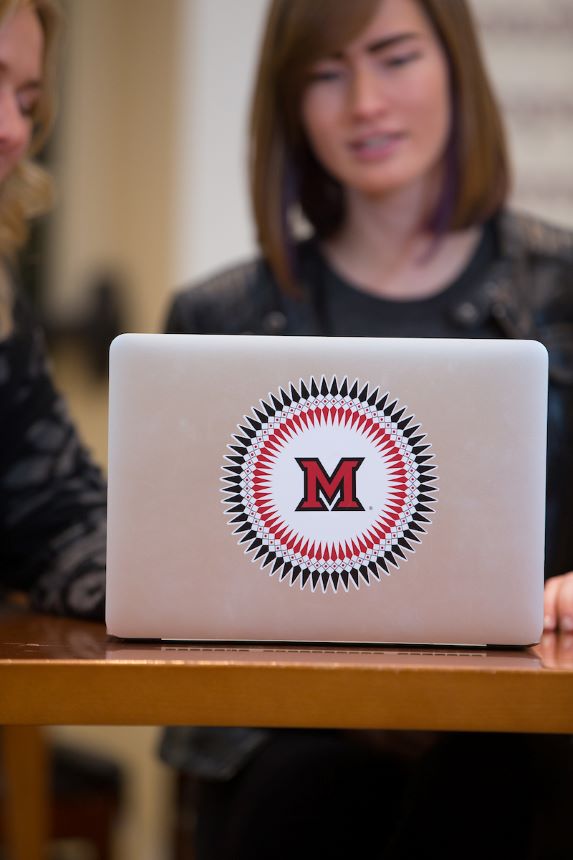 Students work on laptop.