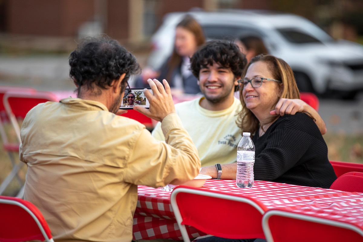 A dad trying to take a photo of his wife and son