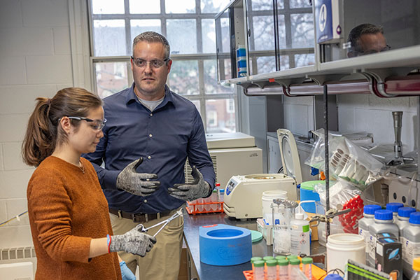 Rick Page, right, associate vice president of research and innovation, talks to a student