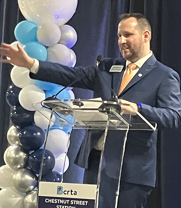 Matt Dutkevicz gestures from the podium