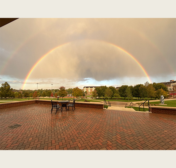 Double rainbow touching “Capturing The Scent of Rain” behind the Engineering quad