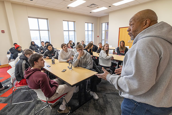 Rodney Coates talks with Miami University men's and women's basketball teams