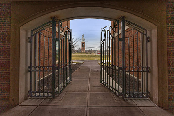 wrought iron doors at the bachelor hall courtyard frame pulley tower in the background