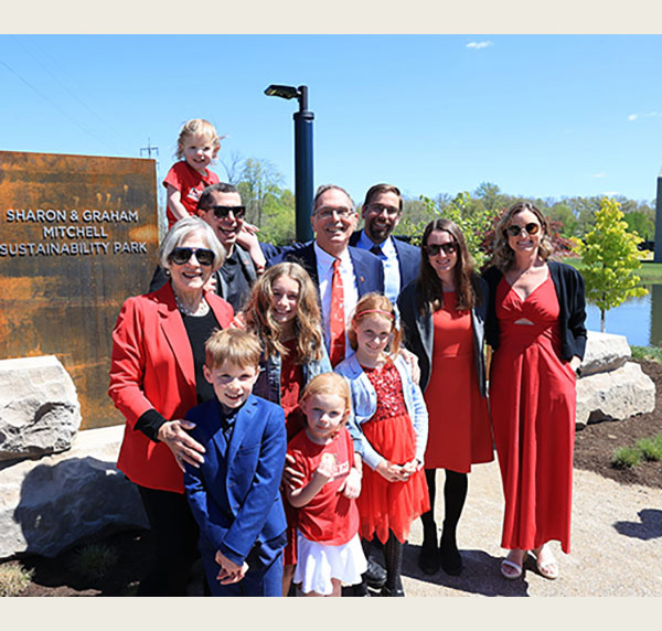 Sharon and Graham Mitchell, Mark and Steve Mitchell, Stacey and Abby Mitchell and 5 children pose at the main gateway 
