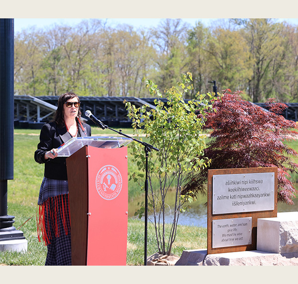 Nichole Prescott speaks at a podium at the Mitchell Sustainability Park main gateway