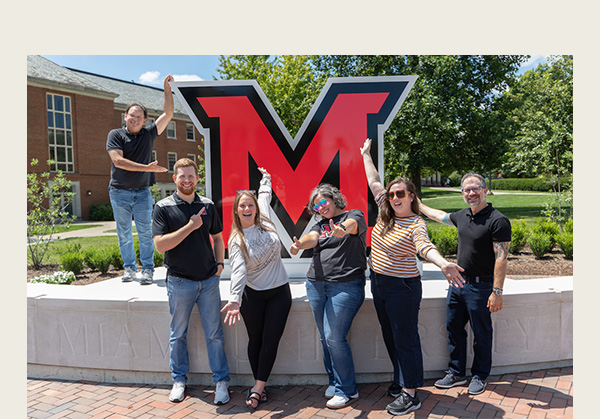 Members of the office of University Communications and Marketing pose at the new RedHawk Plaza (photos by Scott Kissell)