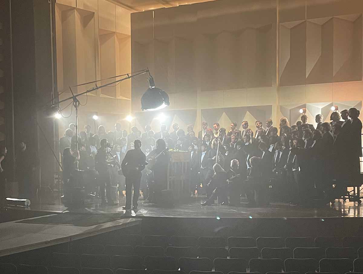 The Glee Club on the stage at Hall Auditorium with lighting equipment and stage fog