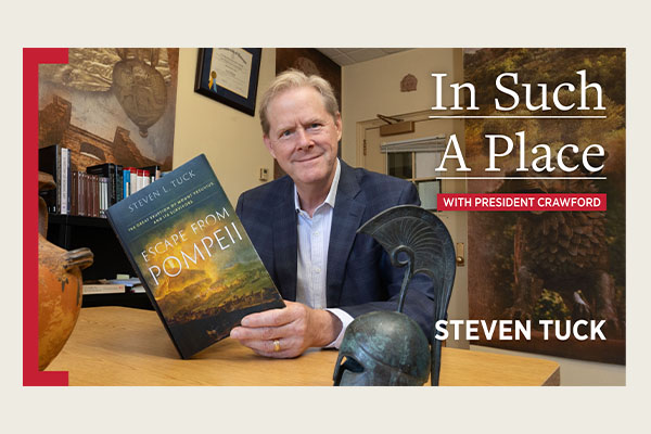 Steven Tuck with In Such a Place logo