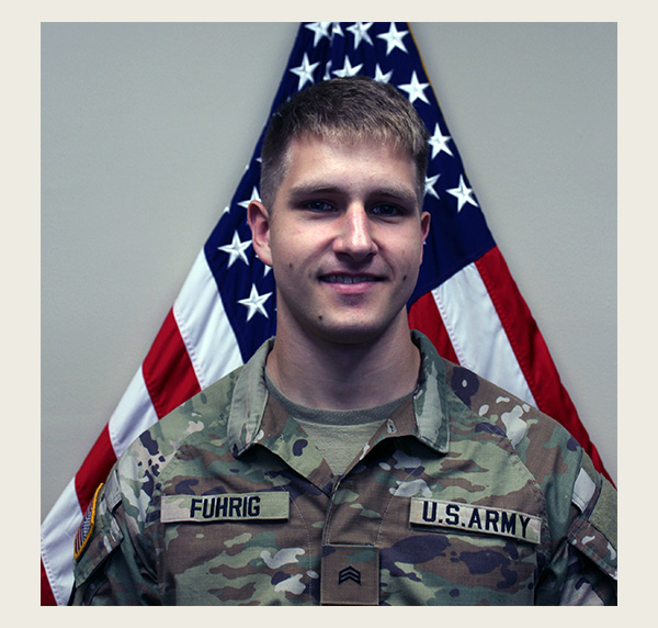 Max Fuhrig in front of an American flag folded in a triangle