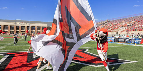 Swoop runs with a Miami flag