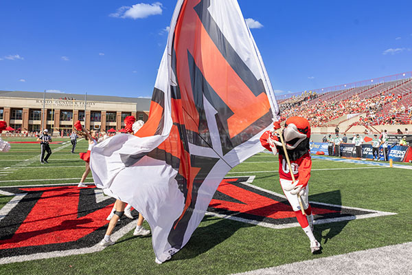 Swoop runs with a Miami flag