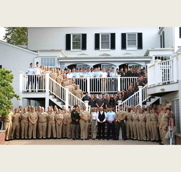 A recent NROTC unit is photographed at Lewis Place with Miami President Gregory Crawford and Miami Ambassador Dr. Renate Crawford.
