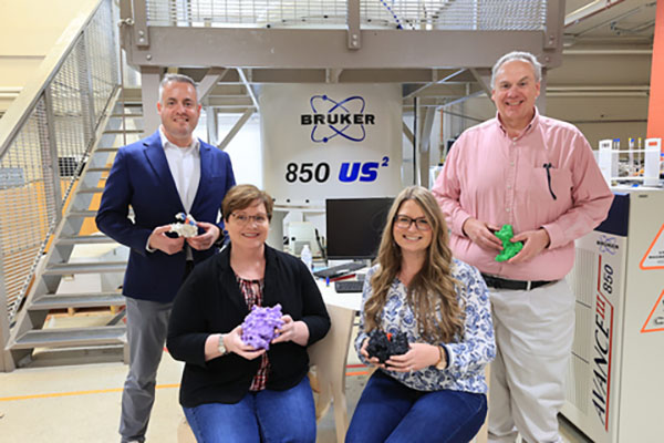 Protein researchers in the Department of Chemistry and Biochemistry hold models of some of the molecules they study.  Left to right: Rick Page, Carole Dabney-Smith, Andrea Kravats, and Gary Lorigan 