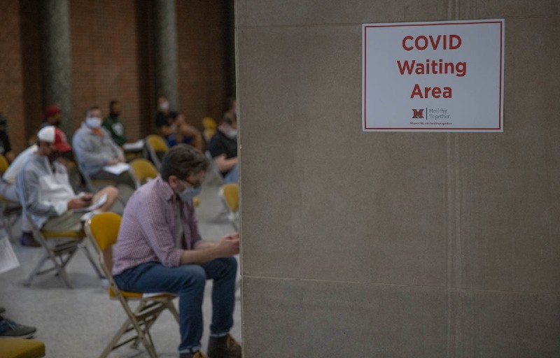 Students sitting in an area designated the COVID waiting area