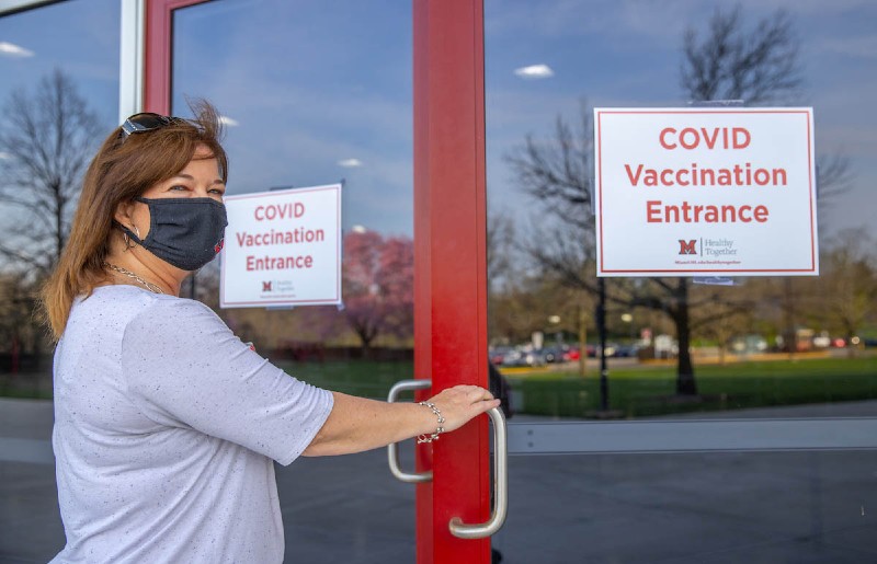 Woman holding the door handle about to walk into the clinic 