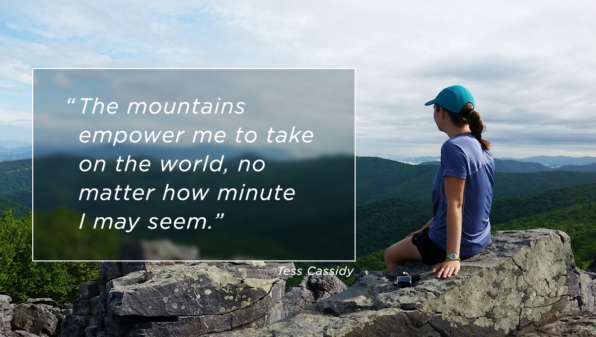 The mountains empower me to take on the world, no matter how minute I may seem. Photo of Tess sitting on the top of a mountain, gazing out at the mountainous Appalachian landscape