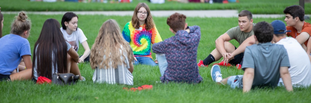  Students in group discussion on lawn