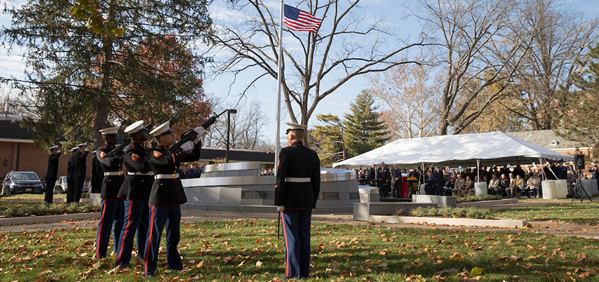 A gun salutes at the Alumni Veterans Tribute dedication ceremony