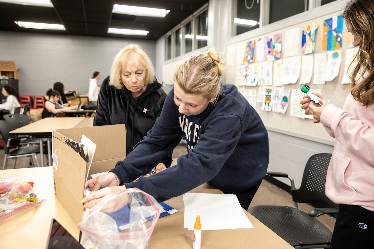 A CCA professor instructs a student who is working on a design project.