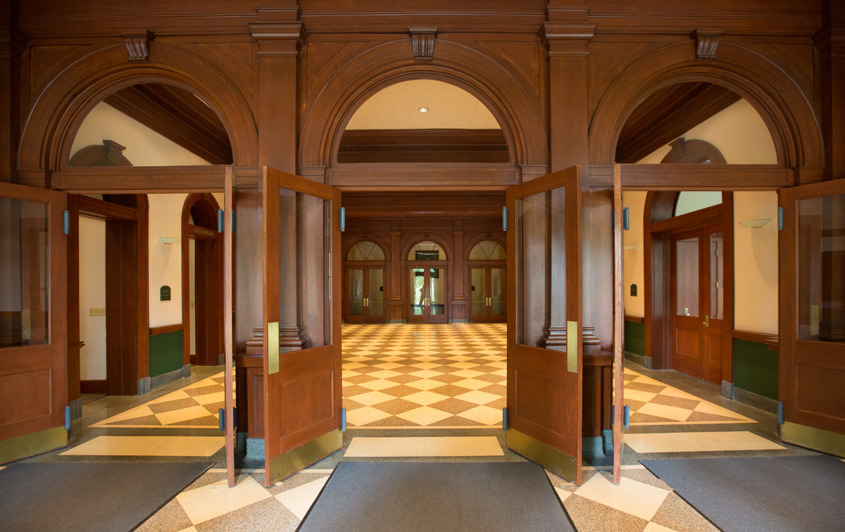  doors opening up to the entry of hall auditorium