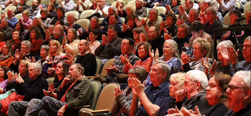 Audience members clapping after a performance at the Dave Finkelman Auditorium.