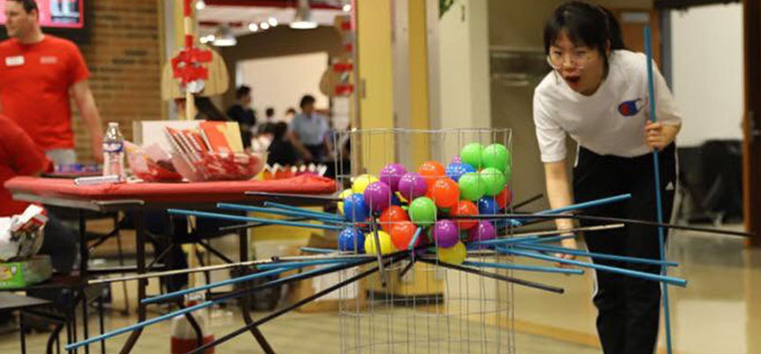 A student playing a activity in the galleria of the Miriam G. Knoll Campus and Community Center.