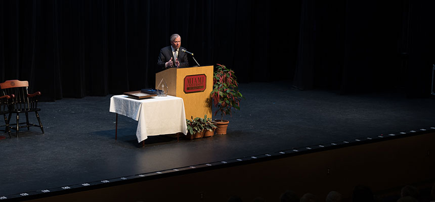  A speaker at the podium on the stage of Parrish Auditorium. 