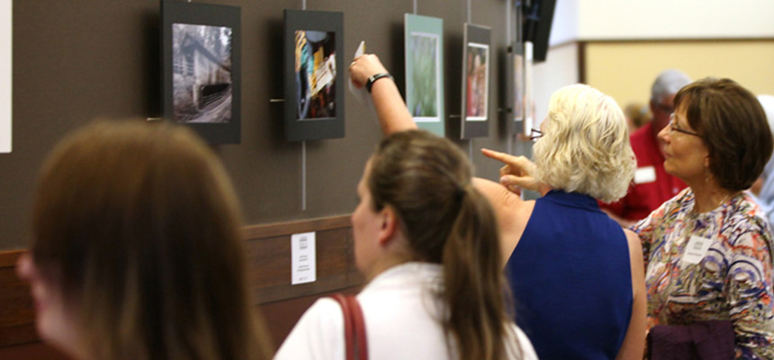  Visitors looking at artwork during an art show.