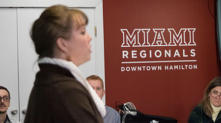 A woman speaking to a group of people at the Miami Hamilton Downtown center. 
