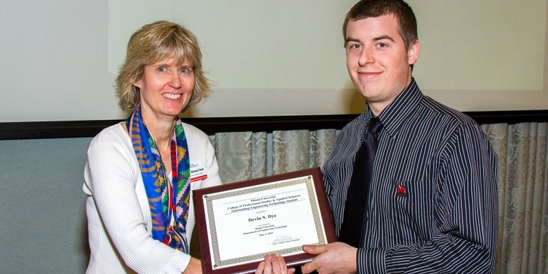 Dr. Clark presents an award to a student