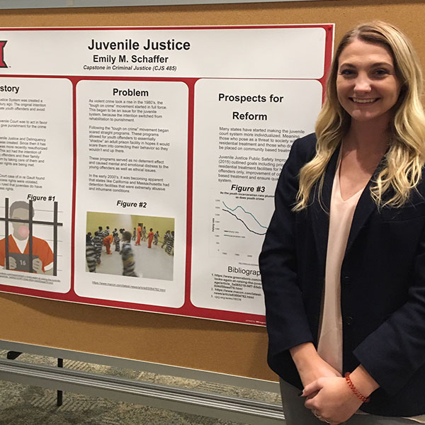 Emily Schaffer standing next to her poster during the Criminal Justice Poster Session on Dec. 3