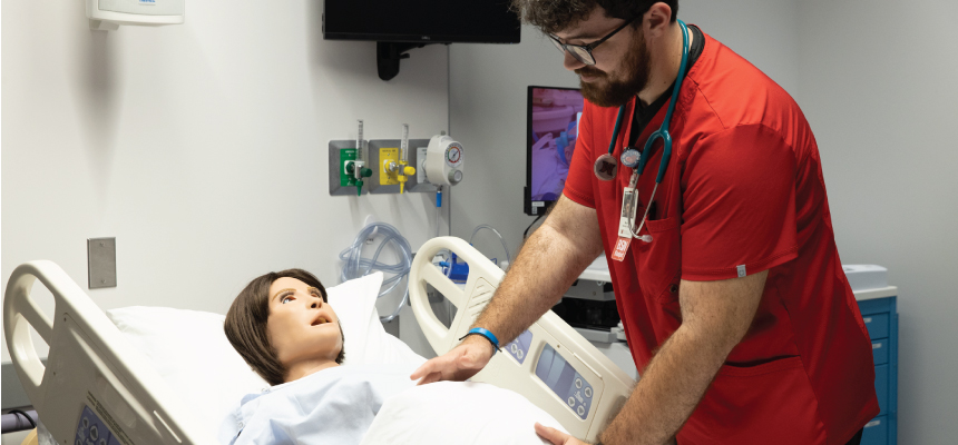  Student checking the stomach of the simulation manikin