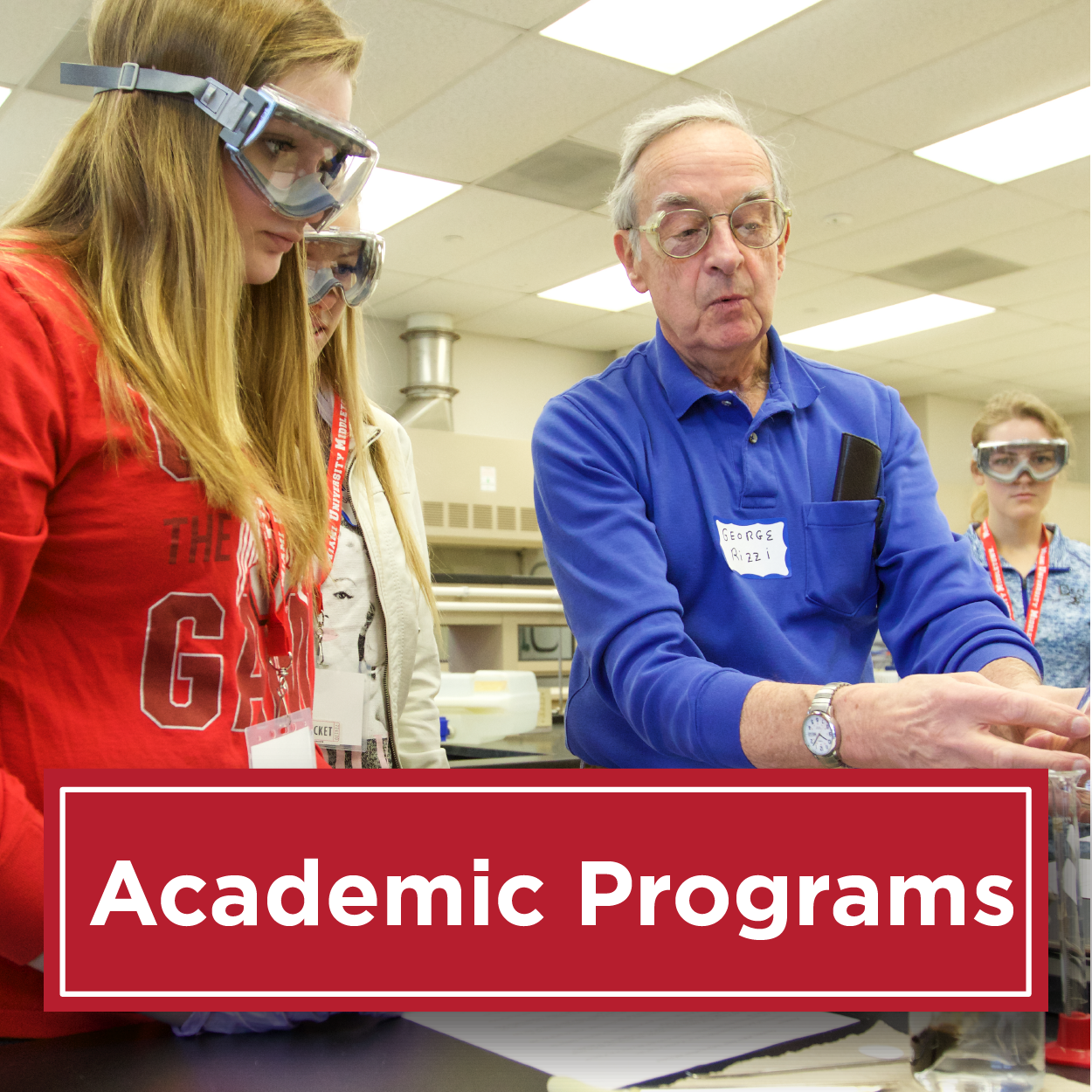 Photo is a student working with chemistry googles on watching a professor with a beaker. Text reads academic programs