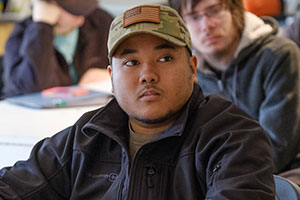 A student sitting at his desk.