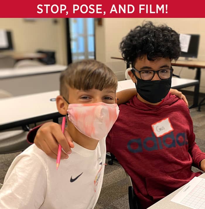 Stop, Pose, and Film! Two students posing for the camera