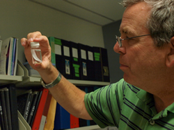 Professor David J. Berg examines a specimen he collected in the Chihuahuan Desert in New Mexico as part of his on-going biodiversity and conservation research.