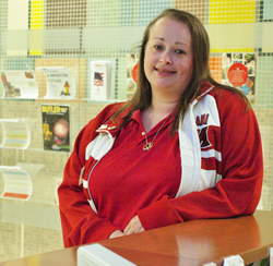 Debi Ellenburg standing at the Information Desk.