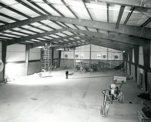 Lynn Darbyshire standing in the middle of the gym construction in February of 1972.