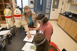 Chemistry education day at Miami Middletown. Professor Susan Marine is helping students work on a project.