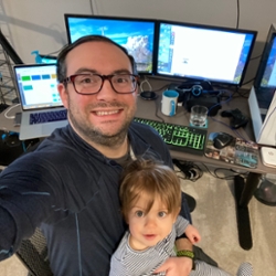 Jeff Kuznekoff with his son on his lap during virtual learning.