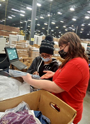 Kiep training how to package and ship orders at the Fischer Group.