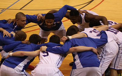 Miami Middletown's men's basketball team in a huddle before the game