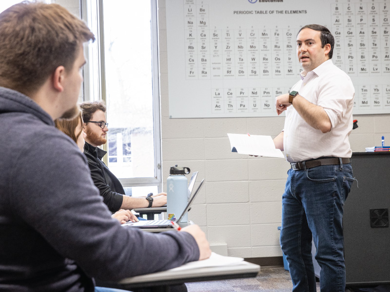 Jeff Kuznekoff teaching to a classroom of students
