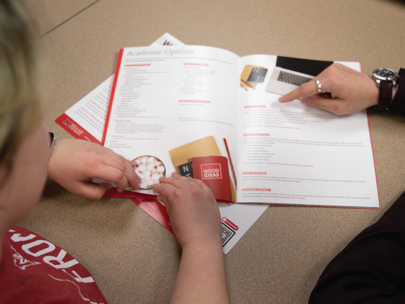 An admission counselor talking through the admission process with a student.