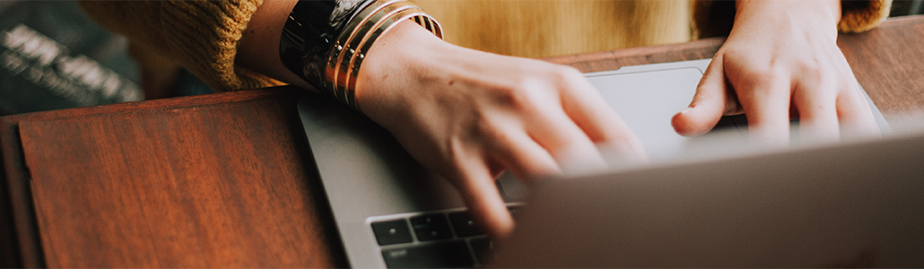 woman typing on a laptop