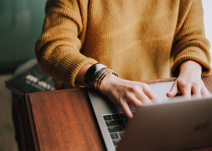 woman typing on a laptop