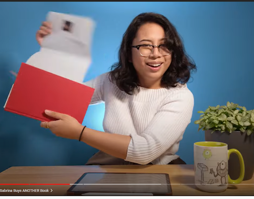 person removing blue book cover
